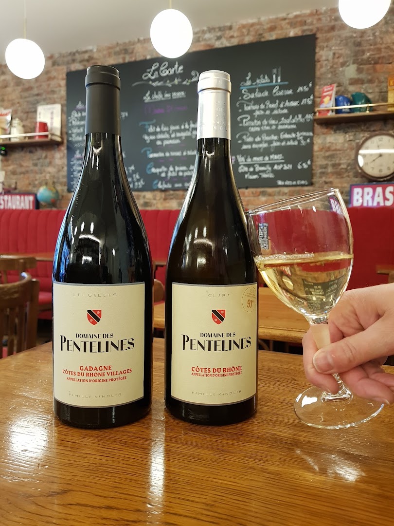 Deux bouteilles de vin blanc et un verre levé